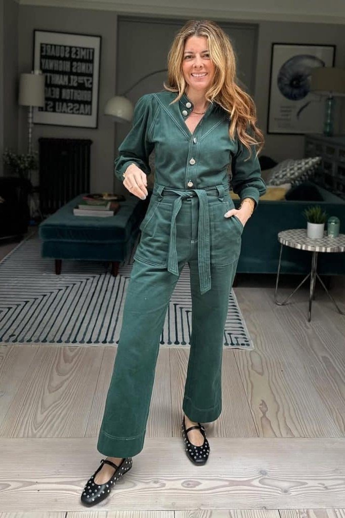 Emerald green belted jumpsuit, living-room setting - classy outfit for women over 40