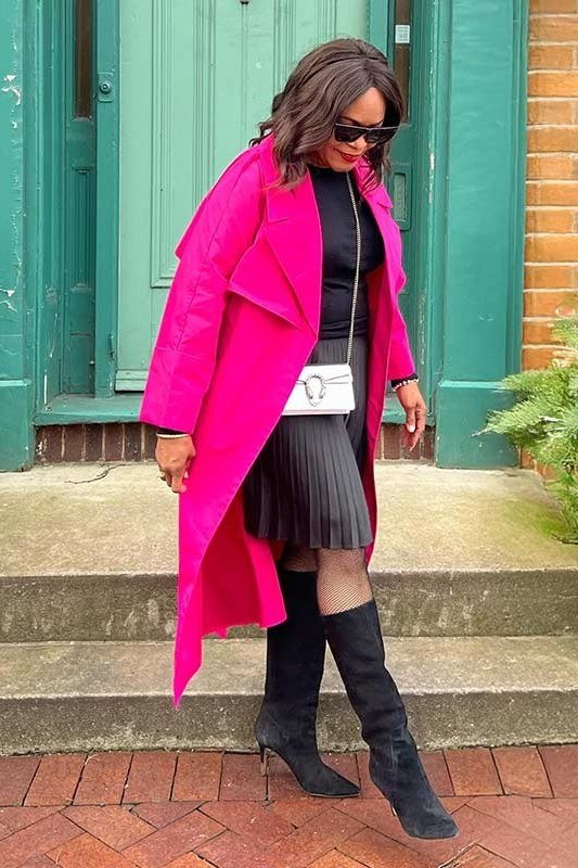 Hot pink long coat + black pleated skirt + black boots, teal door - classy outfit for women over 40