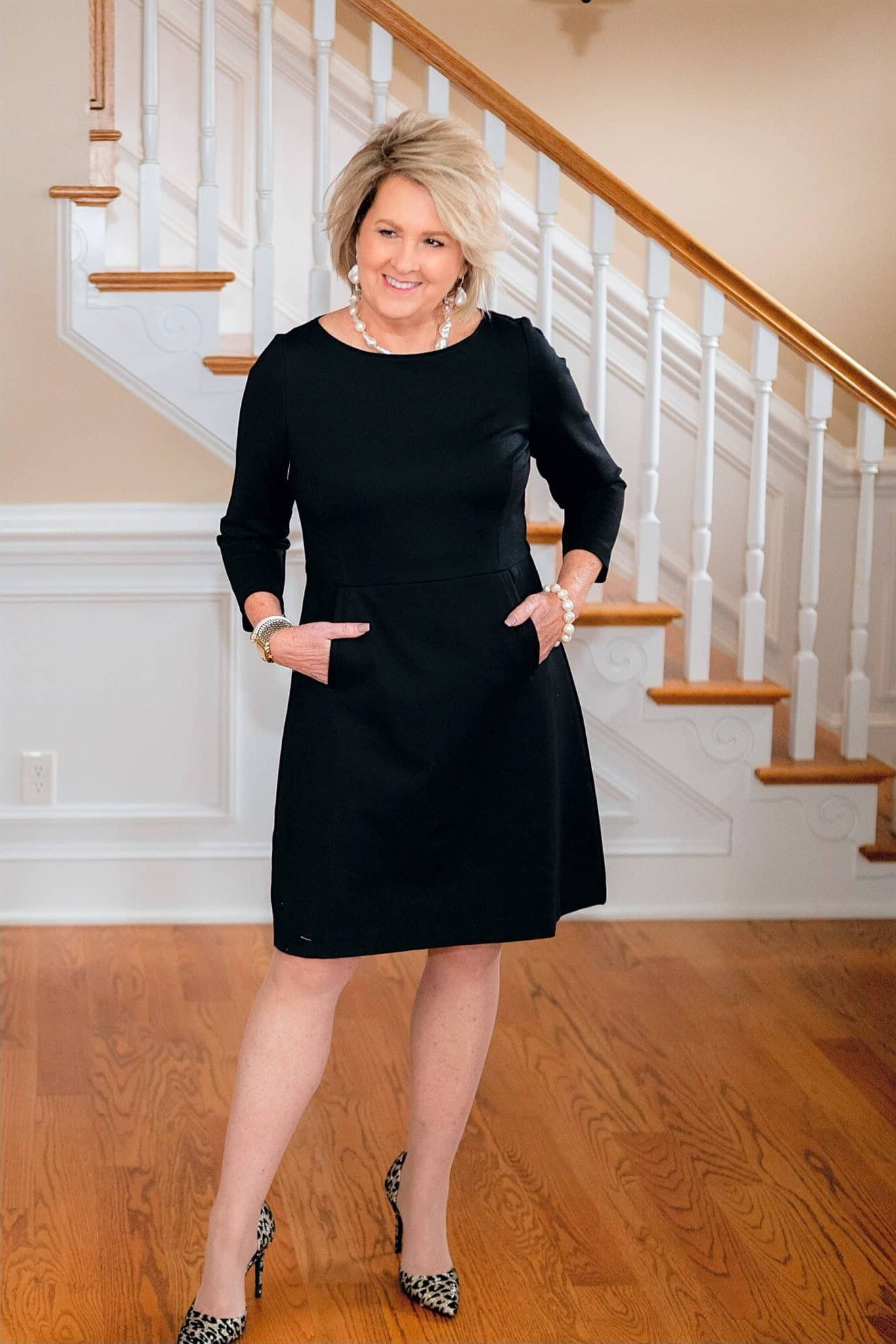 Black Sheath Dress on the Stairs - classy outfit idea for women over 50