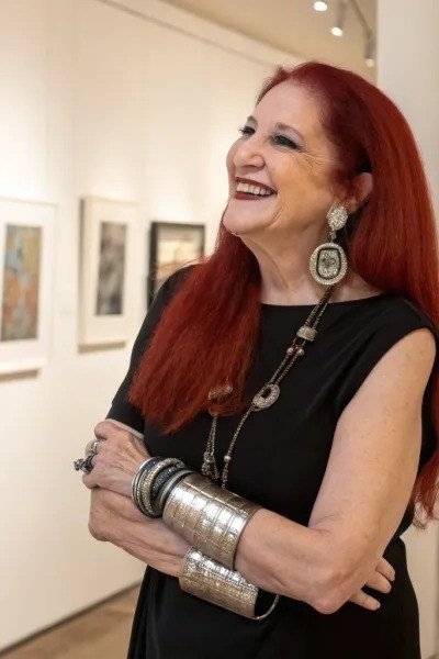 Black Top With Bold Cuffs and Statement Earrings - classy outfit idea for women over 50