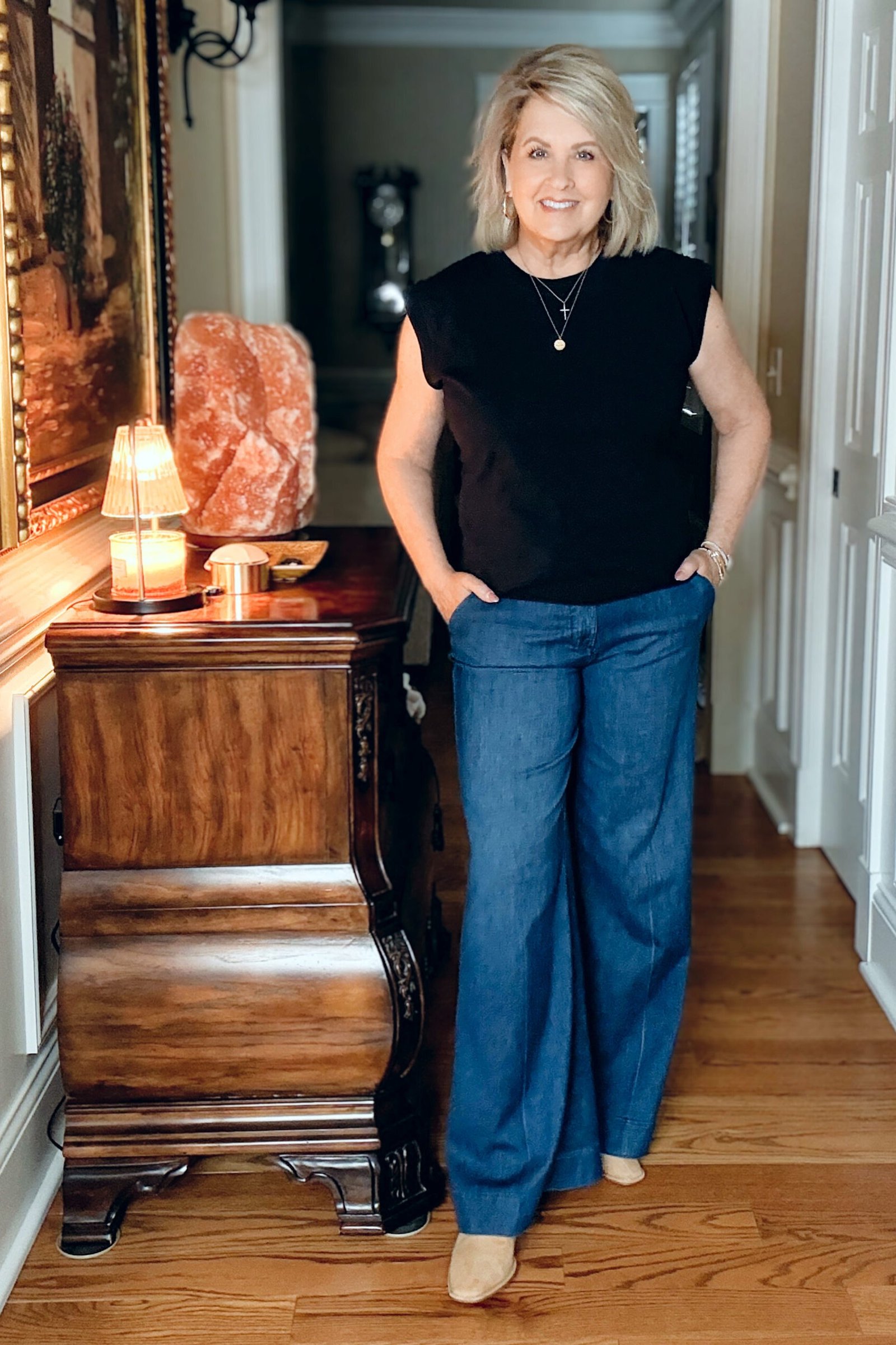 Black sleeveless top with wide-leg jeans, casual outfit for women over 50