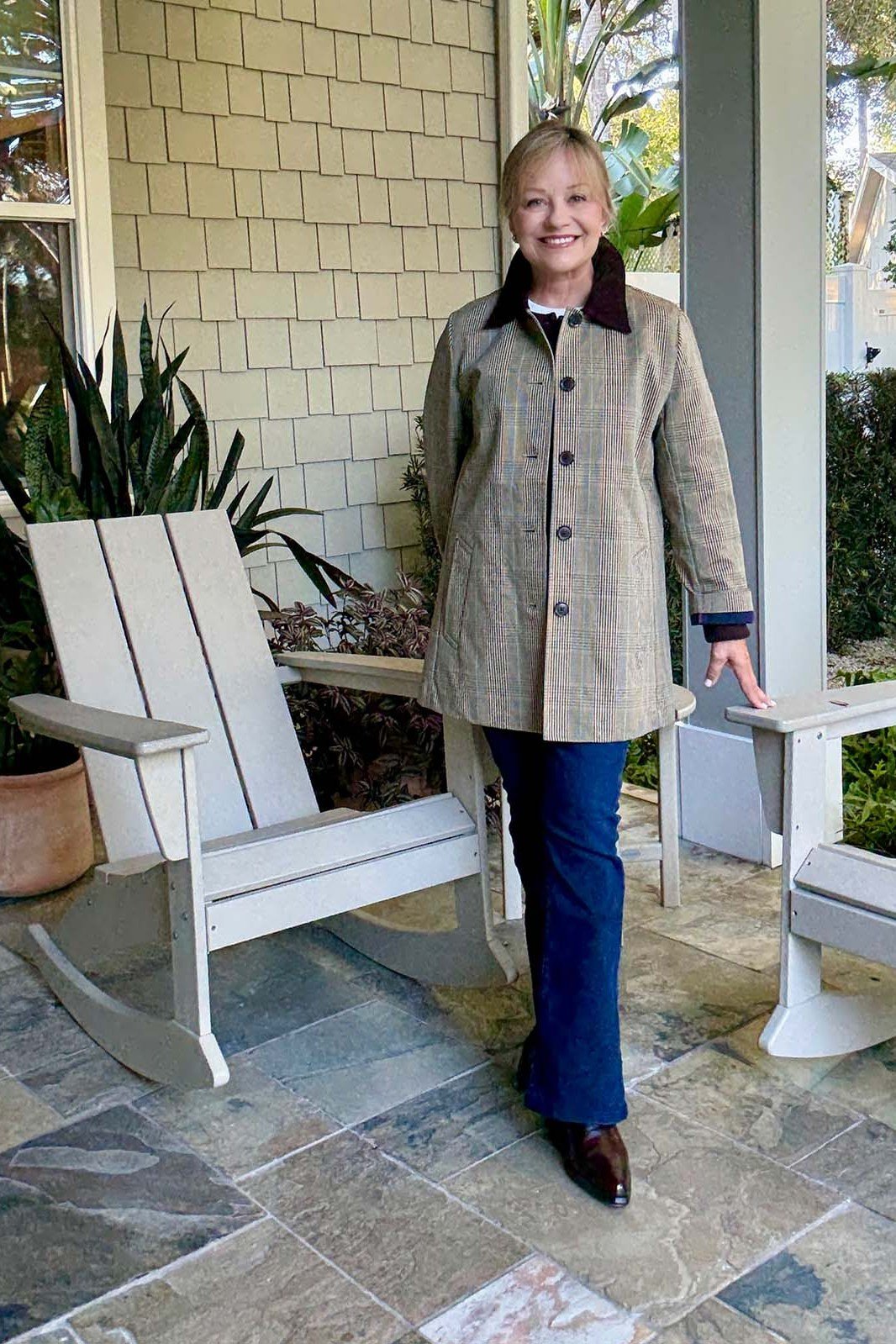 Tweed chore coat with blue jeans on a porch, casual fall outfit for women over 50