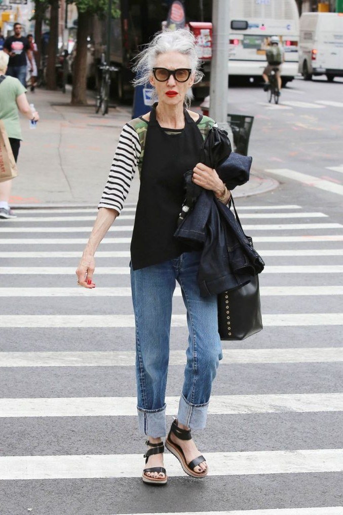 Striped top with jeans carrying a jacket, casual crosswalk outfit for women over 50