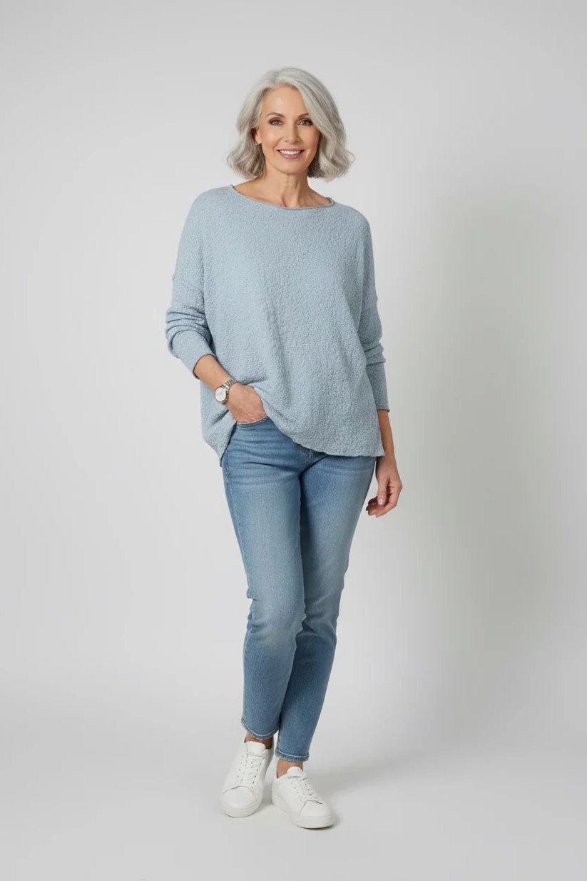 Light blue sweater with light-wash jeans, fresh casual outfit for women over 50