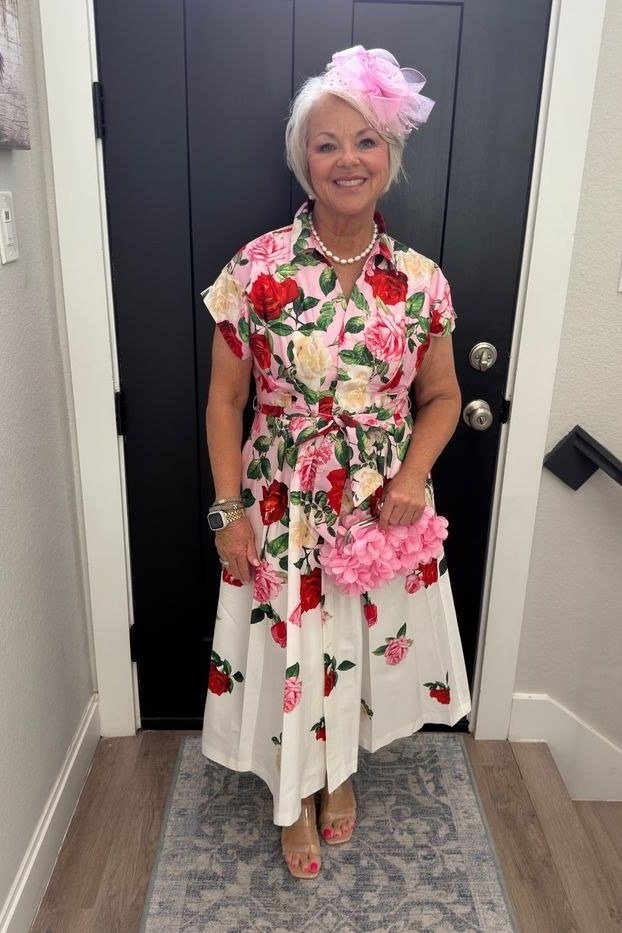 White midi dress with pink floral print and pink fascinator hat, classy casual outfit idea for women over 60