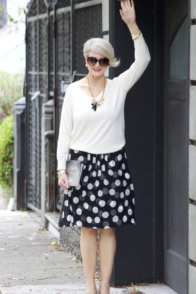 White blouse and black polka dot midi skirt, classy casual outfit idea for women over 60