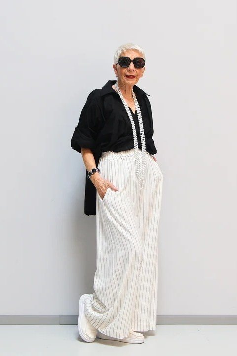 Black shirt and white wide leg pants, classy casual outfit idea for women over 60