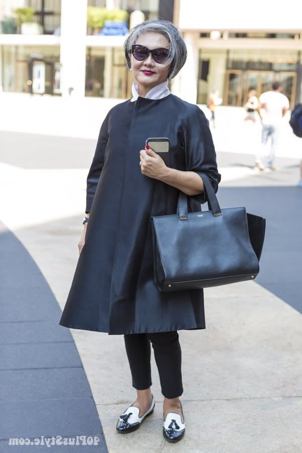 Navy wool coat over black top and black pants, classy casual outfit idea for women over 60