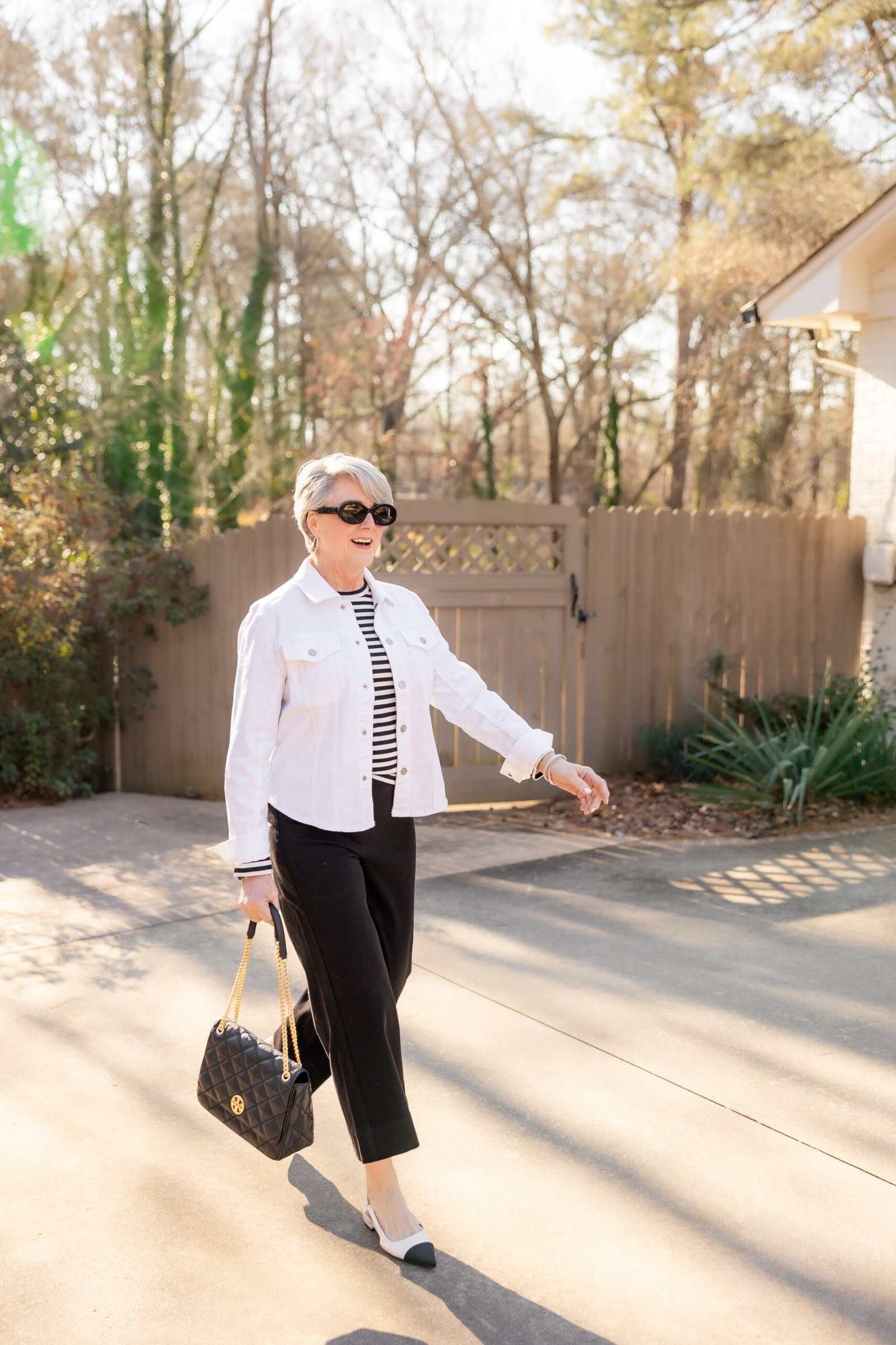 White shirt with striped tie and black pants, classy casual outfit idea for women over 60