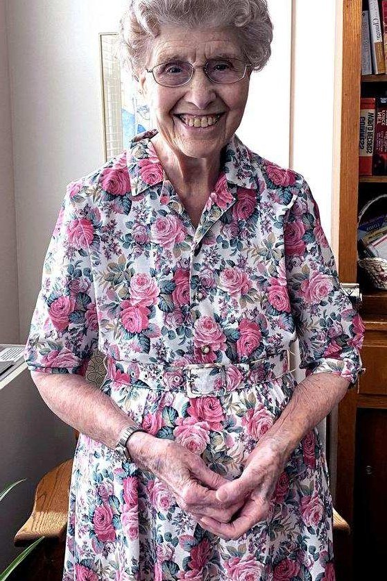 Older woman in pink floral midi dress