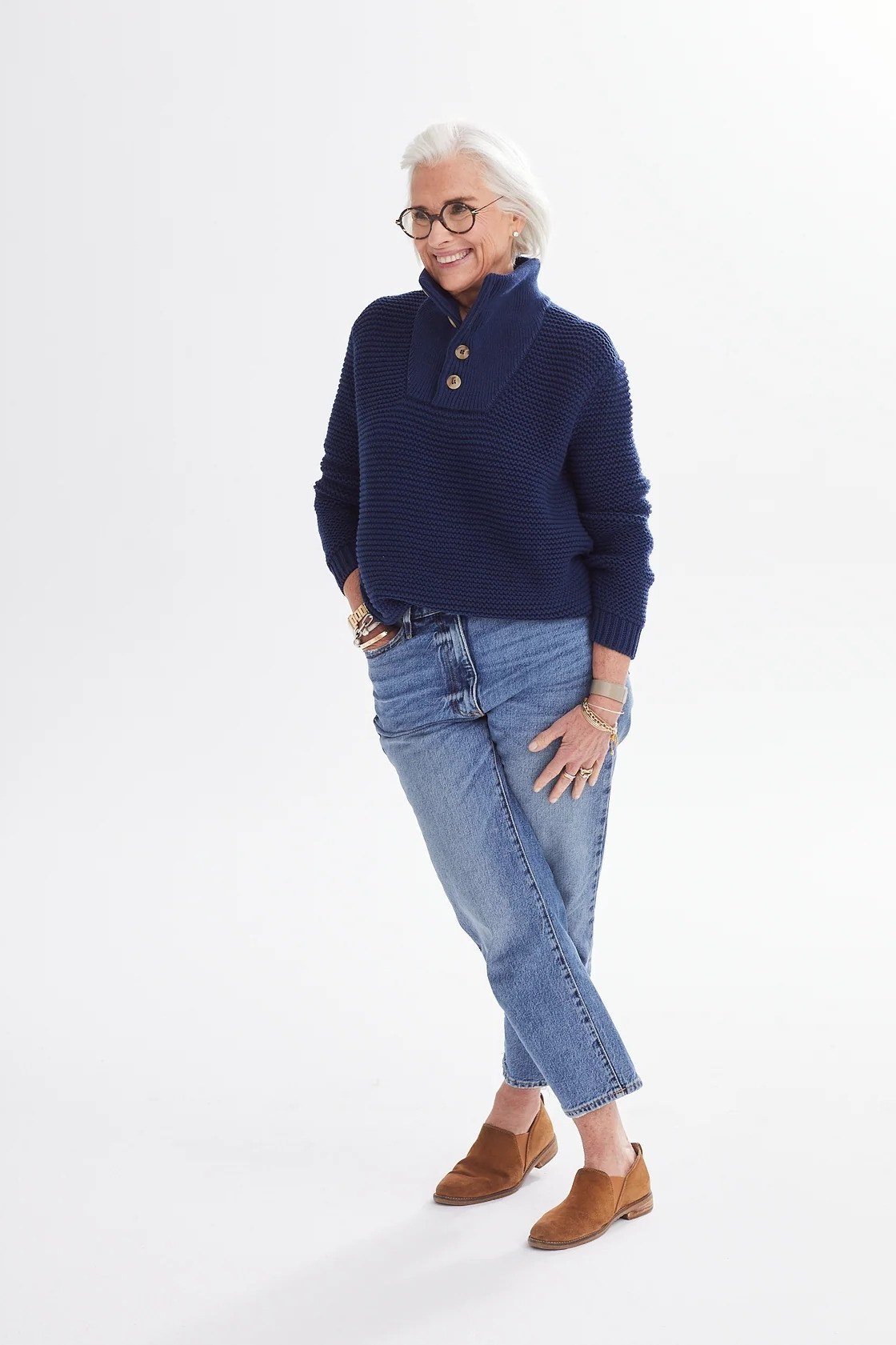 Navy knit sweater with medium-wash jeans and tan loafers - cozy casual outfit idea for women over 50