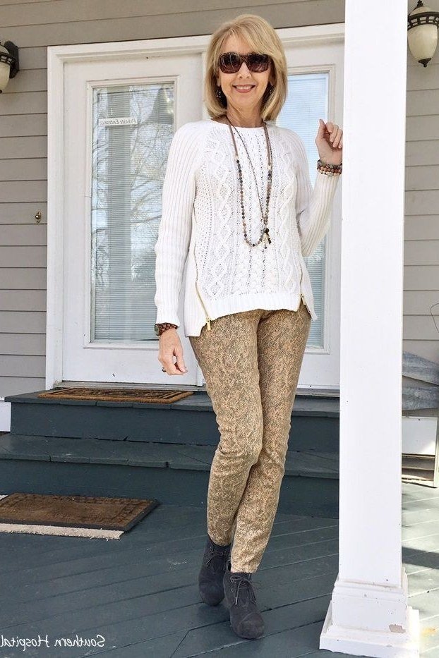 White cable-knit sweater with tan pants, on porch - cozy casual outfit idea for women over 50
