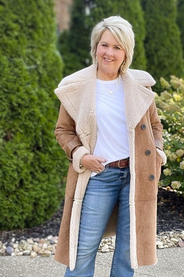 Beige shearling coat with jeans, in garden - cozy casual outfit idea for women over 50