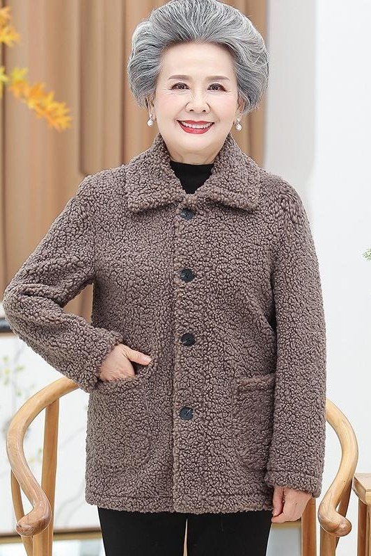 Grey coat with black pants, older woman indoors - cozy casual outfit idea for women over 50