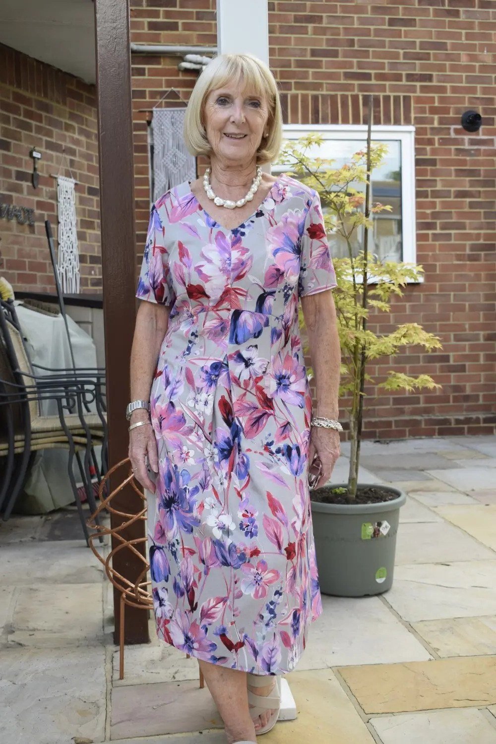 Pink and blue floral maxi dress with pearl necklace