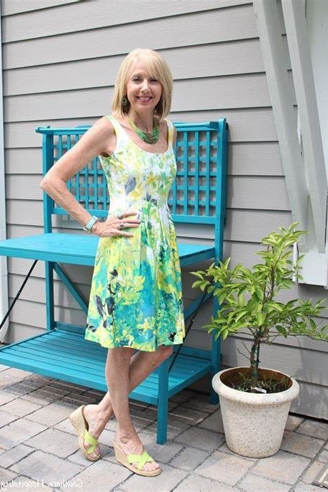 Green and yellow floral sleeveless sundress on porch