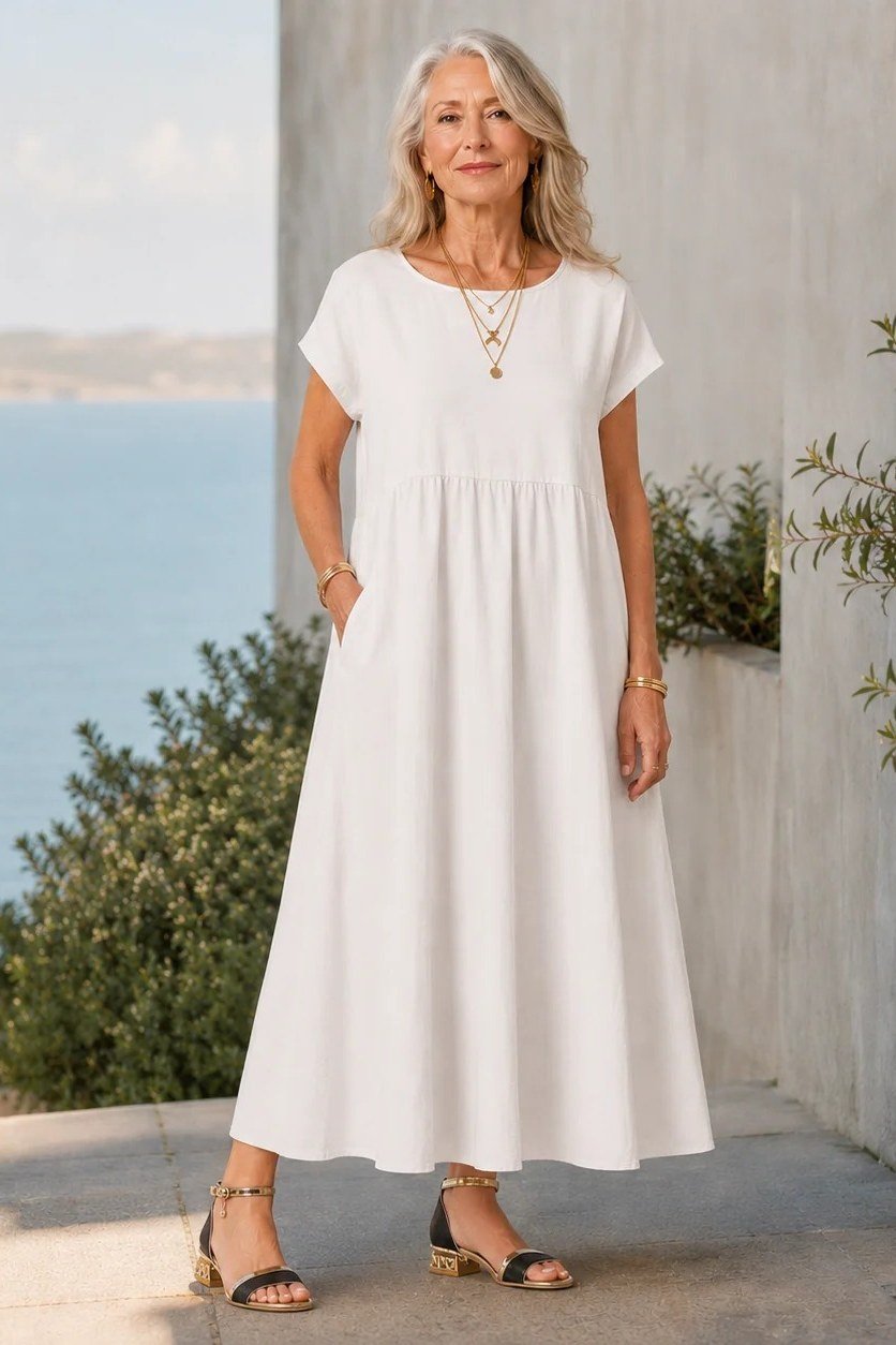 Plain white empire waist maxi dress by the sea