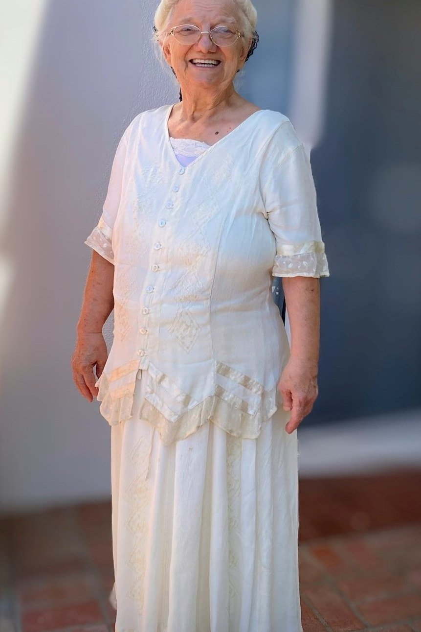 White layered maxi dress with ruffled hem in doorway