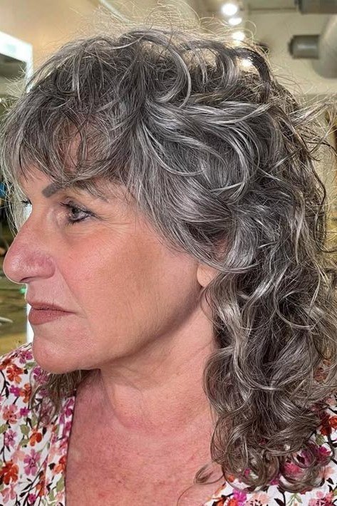 Silver Layered Curly Cut with Bangs curly bangs hairstyle for women over 60