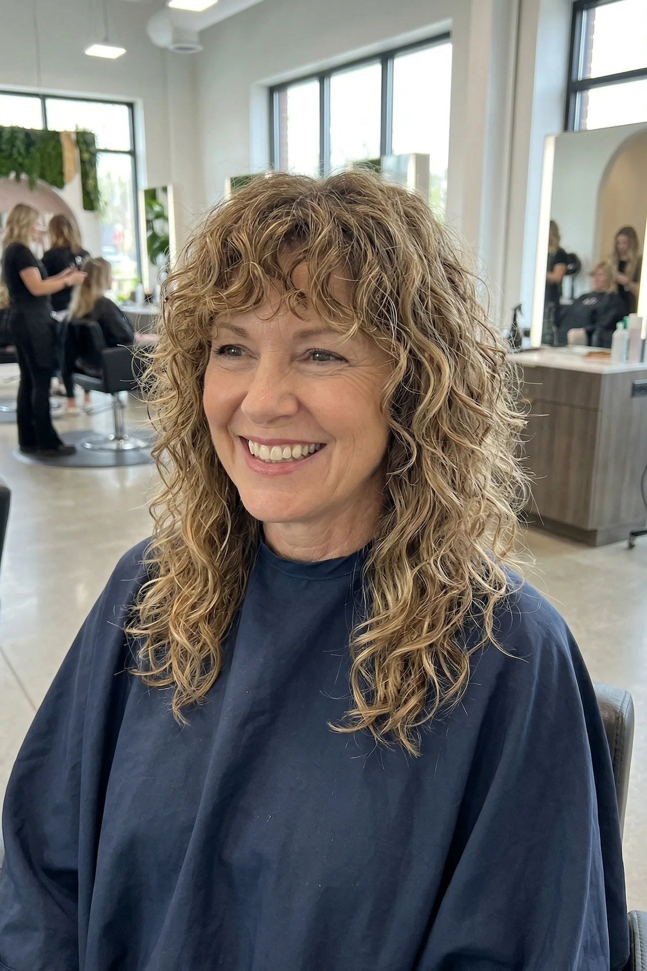 Long Honey-Blonde Curly Hair with Bangs curly bangs hairstyle for women over 60