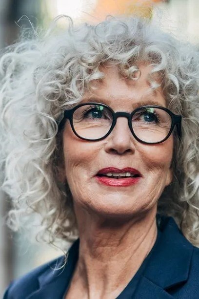 White curly bob with glasses for women over 60