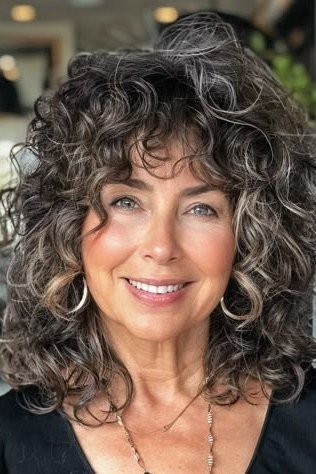 Long Flowing Dark-Gray Curls - silver curly gray hairstyle for older women, idea 24