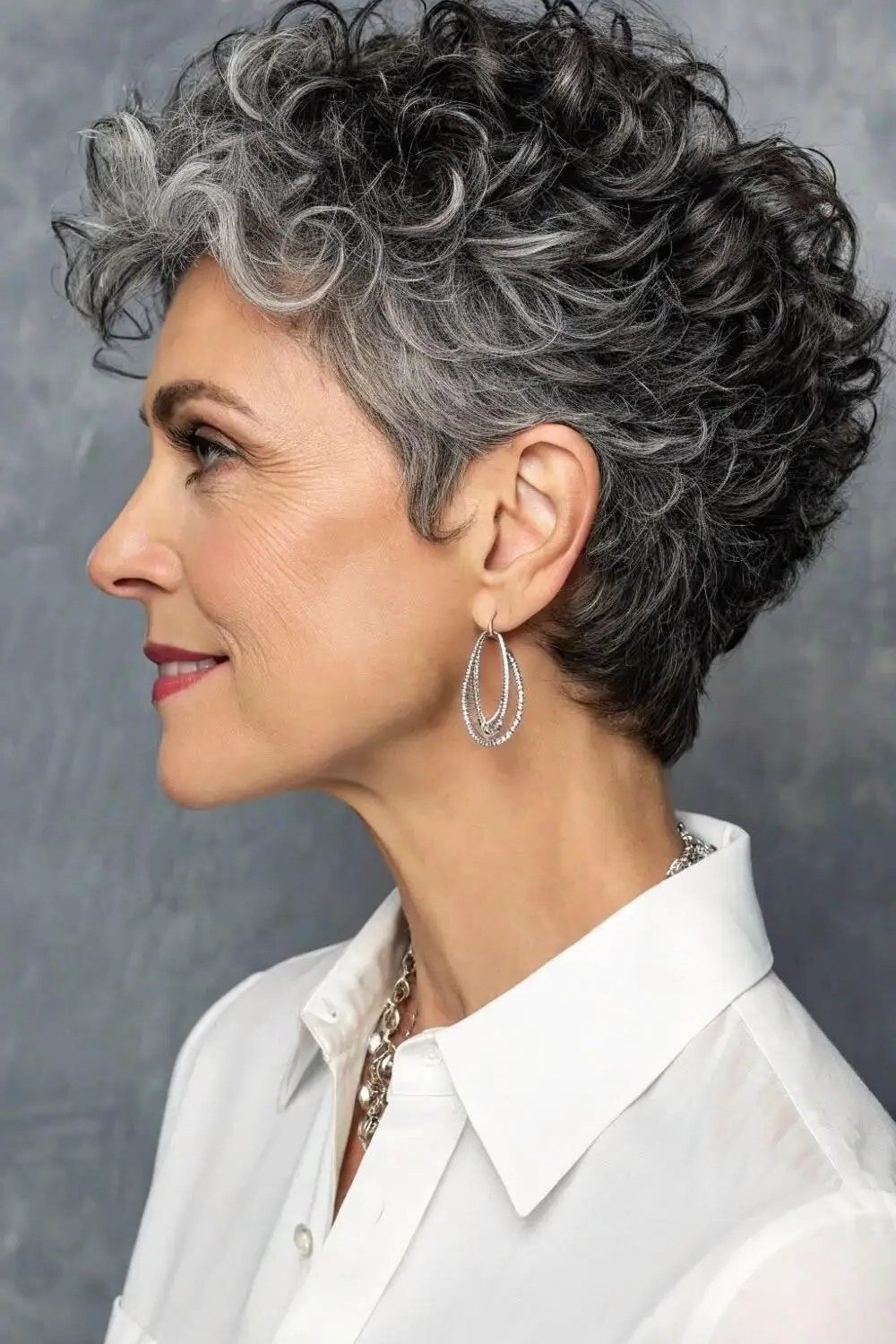 Dark Curly Pixie with a Hoop Earring - silver curly gray hairstyle for older women, idea 28