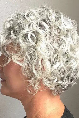 Voluminous White-Silver Curly Bob in Profile - silver curly gray hairstyle for older women, idea 42