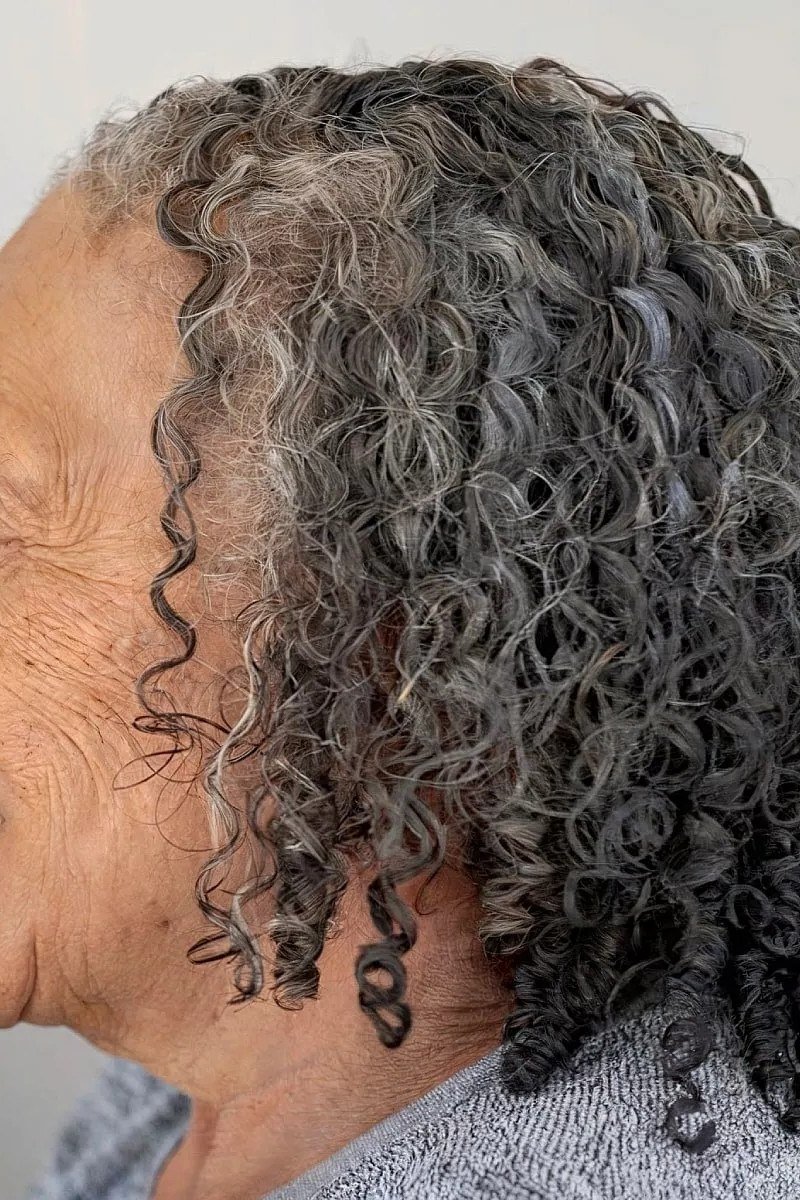Long Dark-Gray Curls in Side View - silver curly gray hairstyle for older women, idea 57