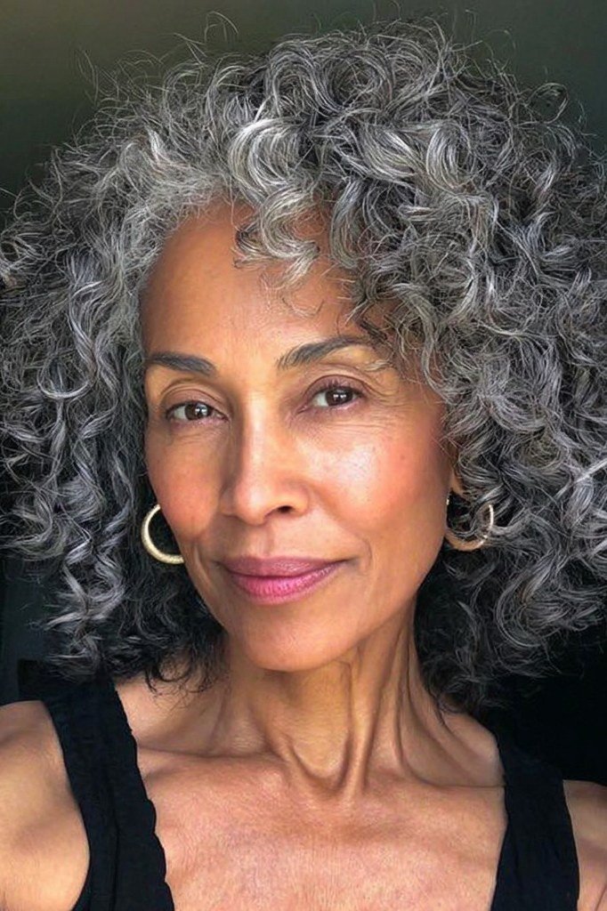 Long Voluminous Dark-Gray Curls with Hoops - silver curly gray hairstyle for older women, idea 65