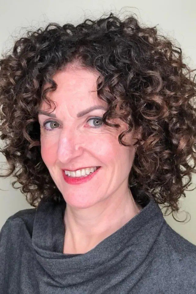 Rich dark brown curly bob hairstyle for women over 60