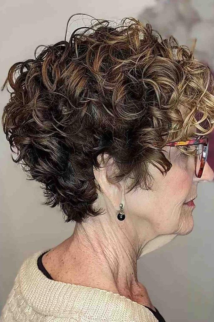 Dark curly bob for women over 60 worn with glasses, side view