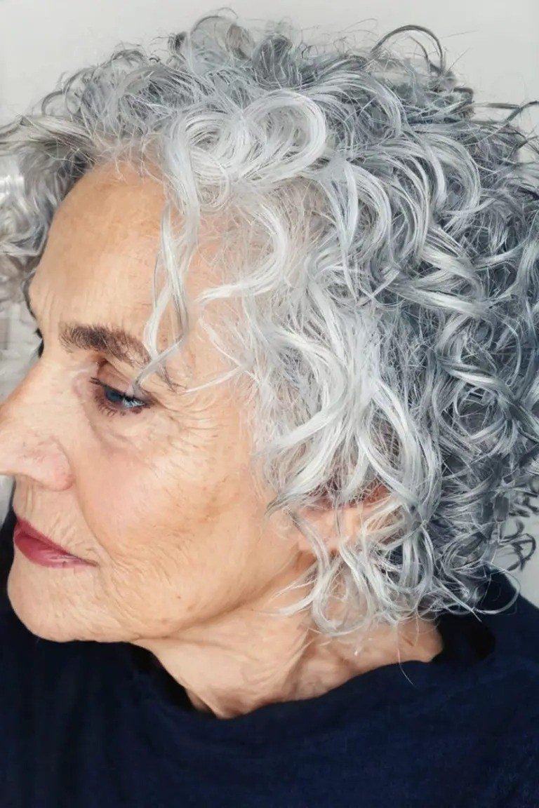 Silver curly bob for women over 60 in side profile