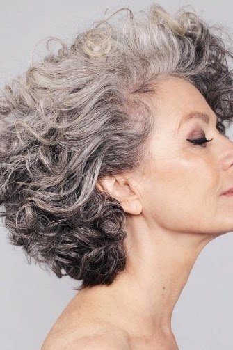 Silver gray wavy curly bob for women over 60, side profile