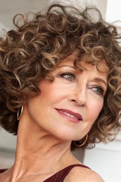 Brown curly bob hairstyle for women over 60, three quarter view