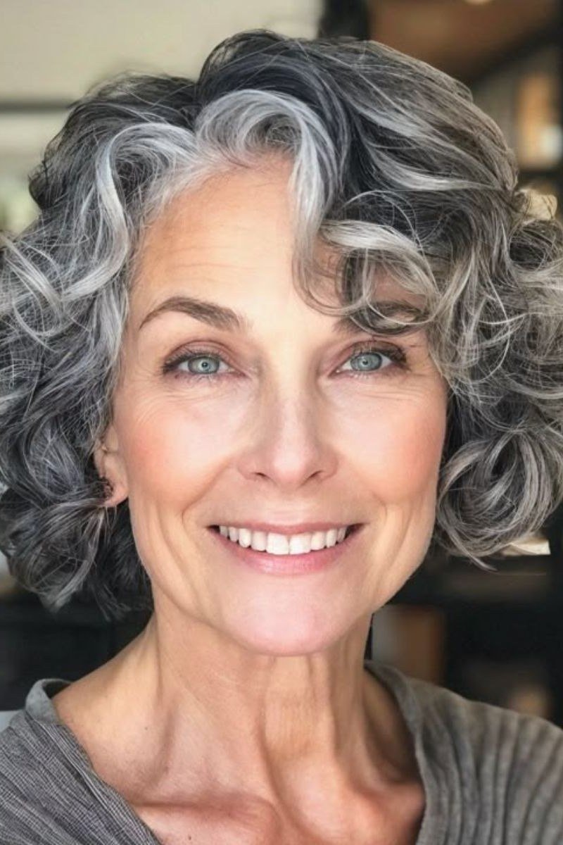 Silver curly bob with polished salon curls on an older woman, curly hairstyles for women over 50