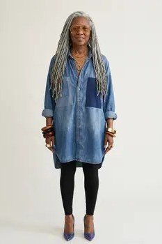 Older woman with long grey braids in chambray shirt dress with leggings and heels, studio - denim dresses for women over 60