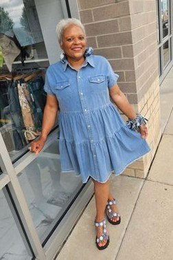 Older woman in denim shirt dress with sandals, by glass door - denim dresses for women over 60