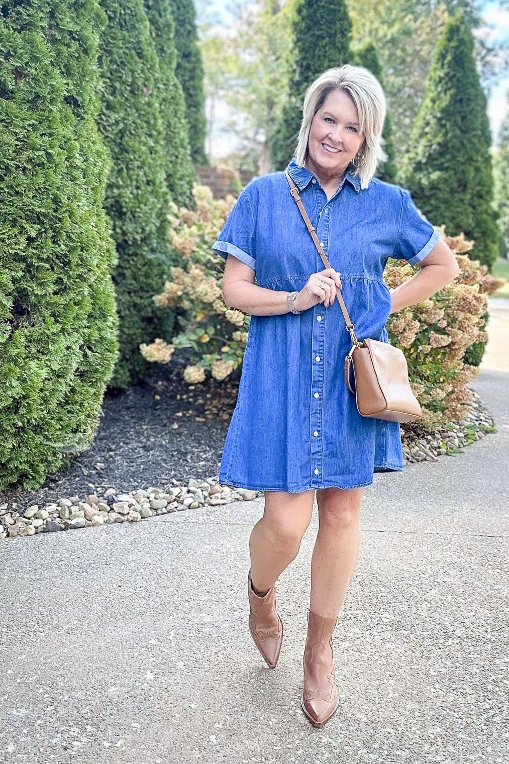 Woman in denim mini shirt dress with ankle boots, cypress trees - denim dresses for women over 60