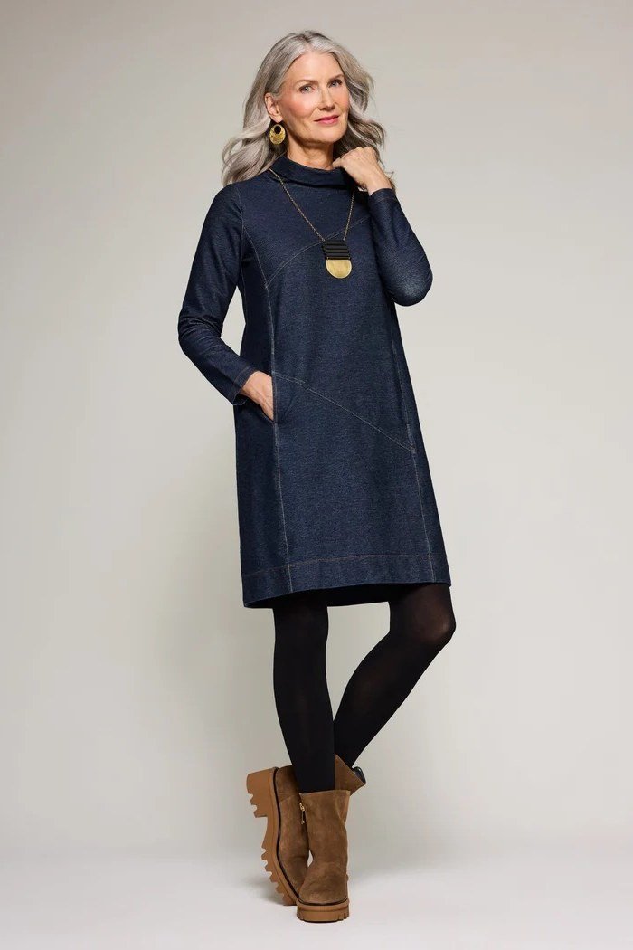 Woman in dark denim shirt dress with black leggings and boots, studio - denim dresses for women over 60