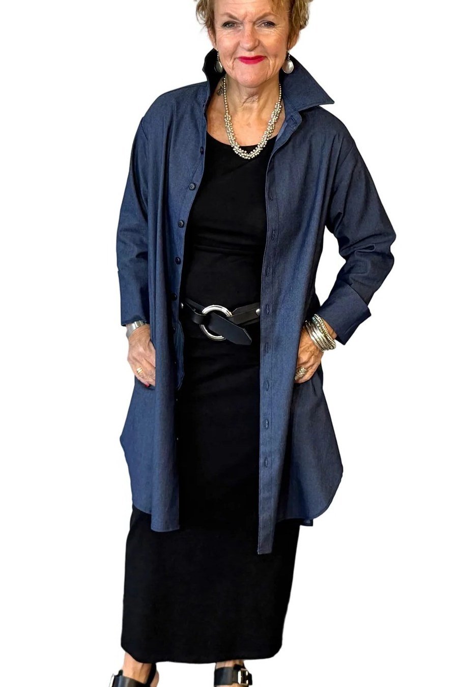 Woman in dark denim shirt dress worn open over black maxi dress, studio - denim dresses for women over 60