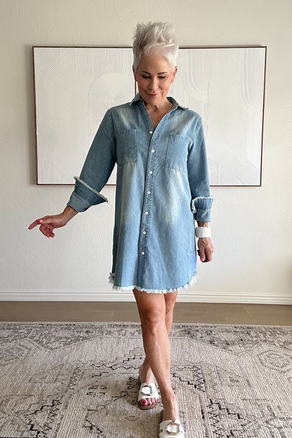 Light denim shirt dress, rolled sleeves, heels, indoors - denim outfit idea for women over 50