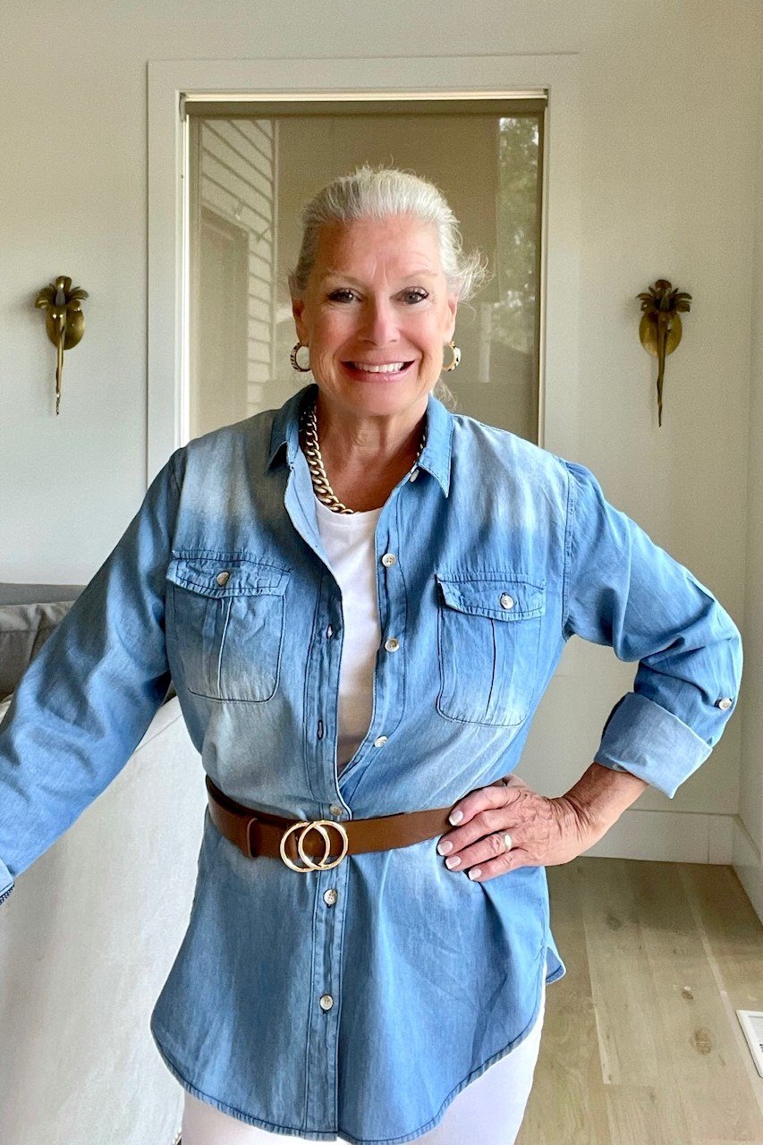 Light chambray shirt with brown belt, hand on hip - denim outfit idea for women over 50