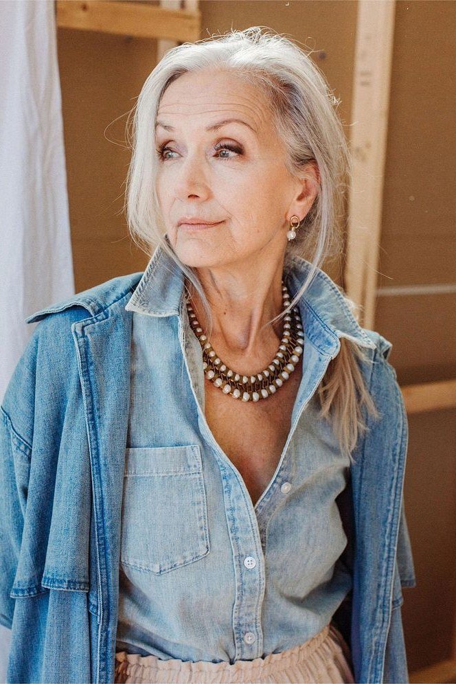 Chambray shirt worn open, statement necklace - denim outfit idea for women over 50