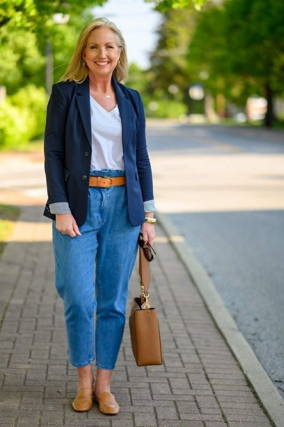 Navy blazer, white tee, light jeans, tan belt, tan bag, city sidewalk - denim outfit idea for women over 50