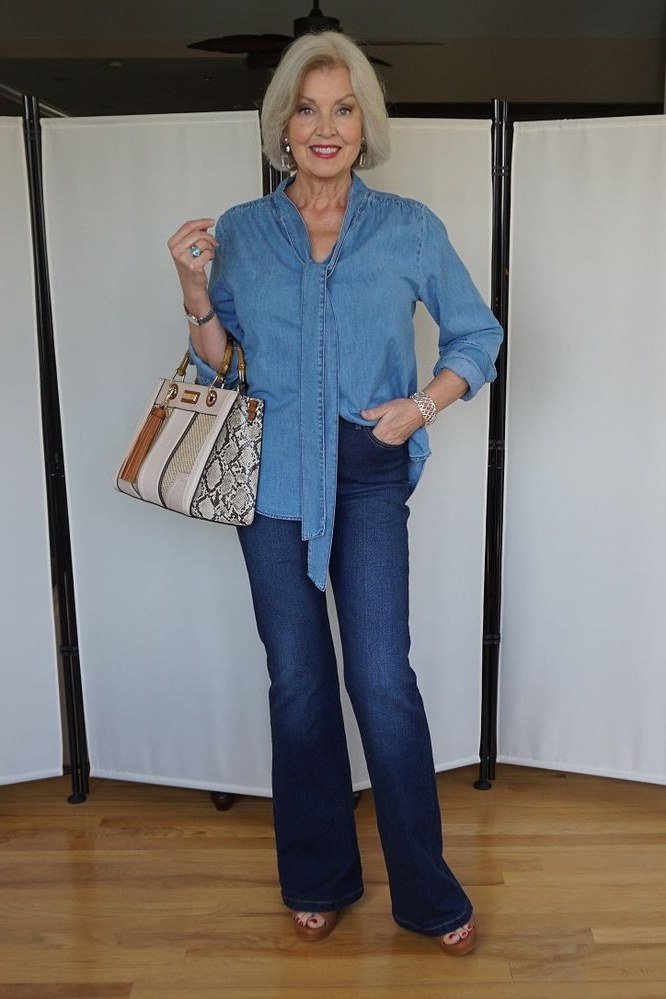 Black tee, dark flared jeans, studio - denim outfit idea for women over 50