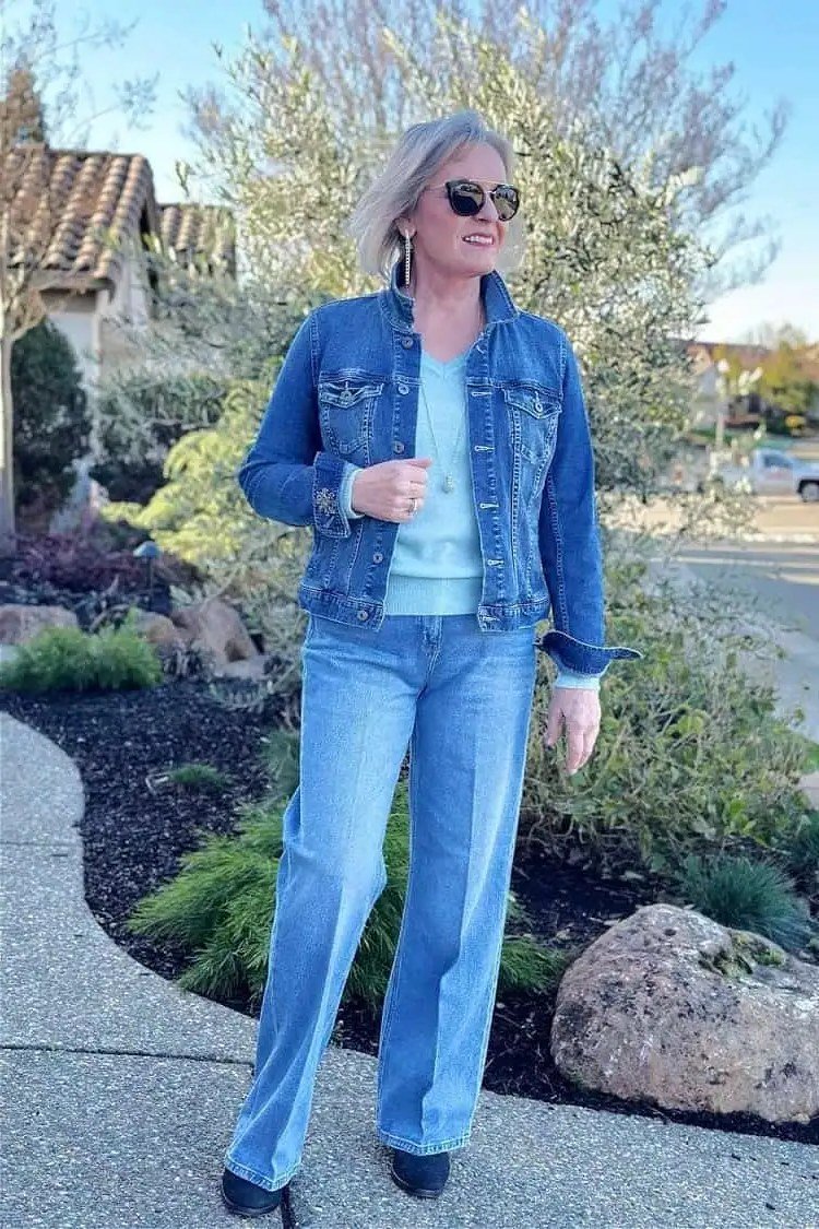 Denim jacket, light jeans, garden path - denim outfit idea for women over 50