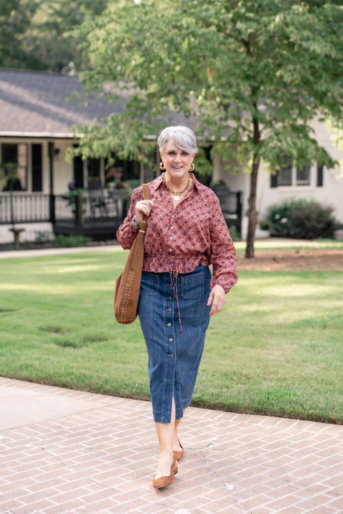 Red patterned top, dark denim midi skirt, outdoors - denim outfit idea for women over 50