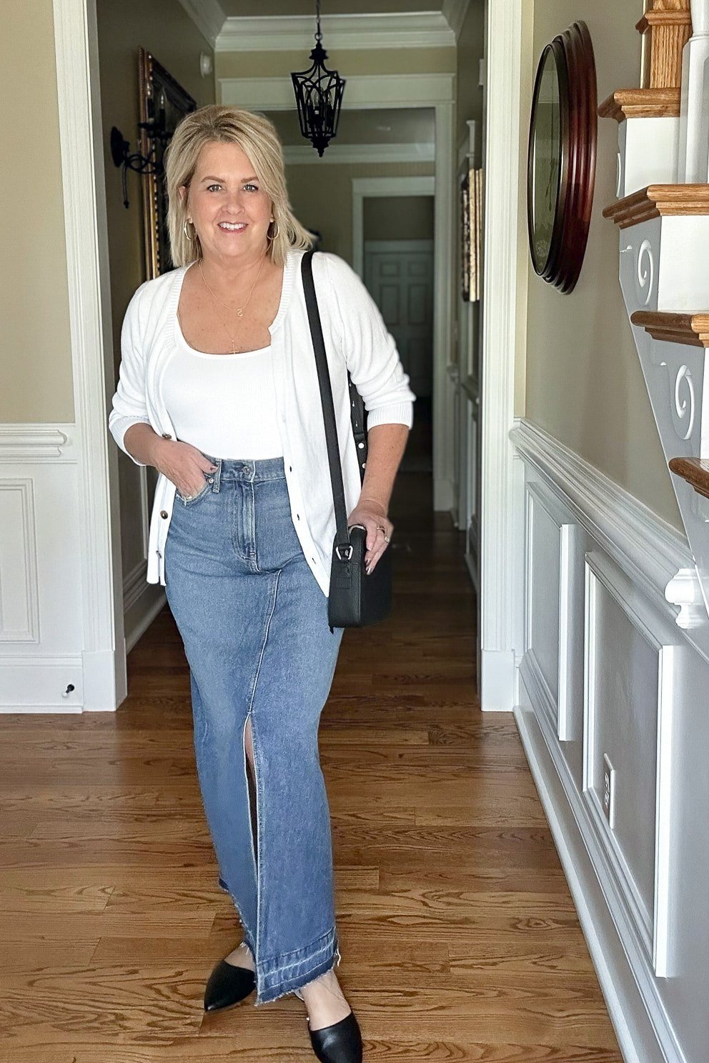 White cardigan, white tee, light wide-leg jeans, hallway - denim outfit idea for women over 50