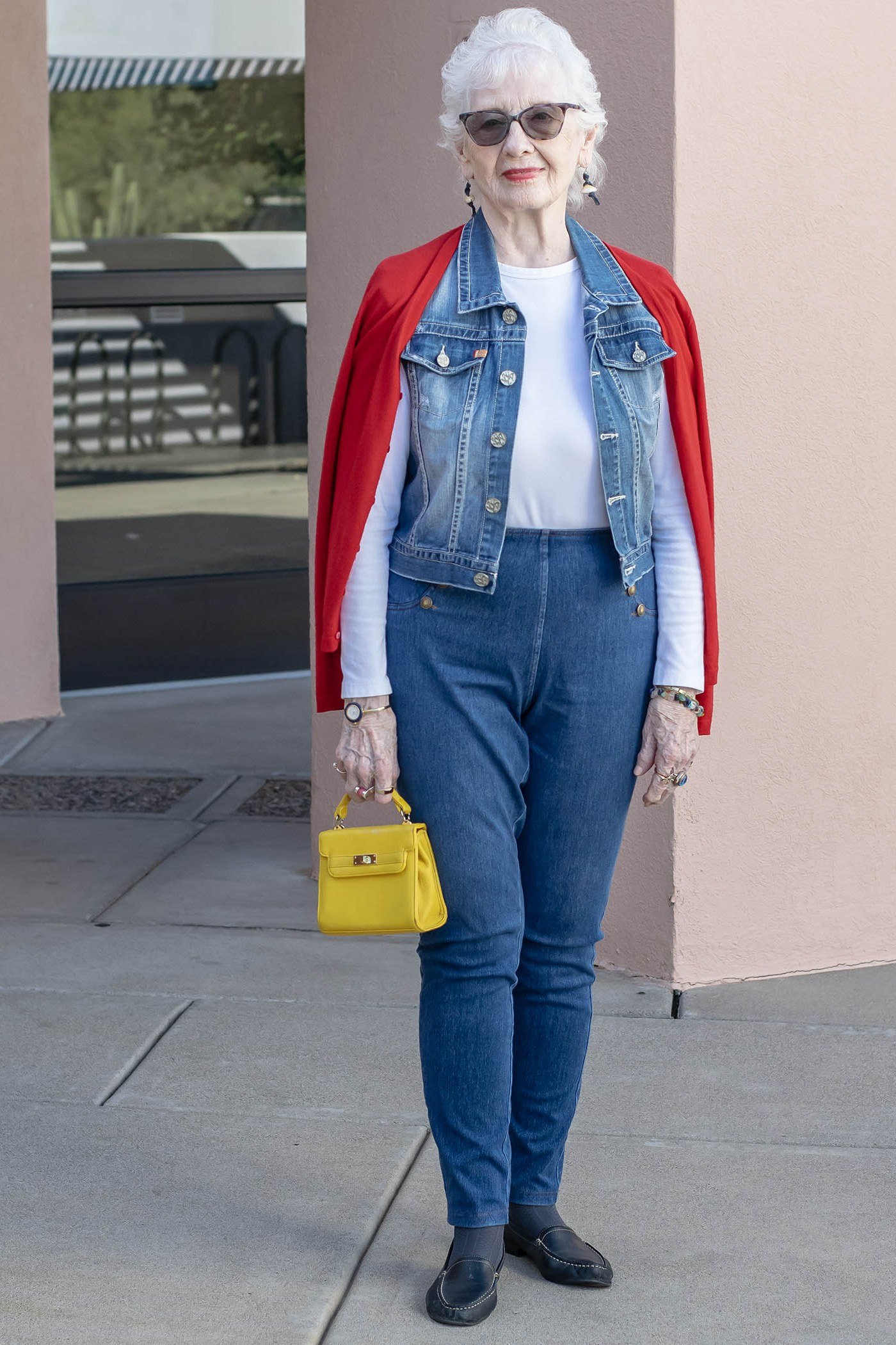 Denim vest, white tee, medium jeans, red shawl, yellow handbag - denim outfit idea for women over 50